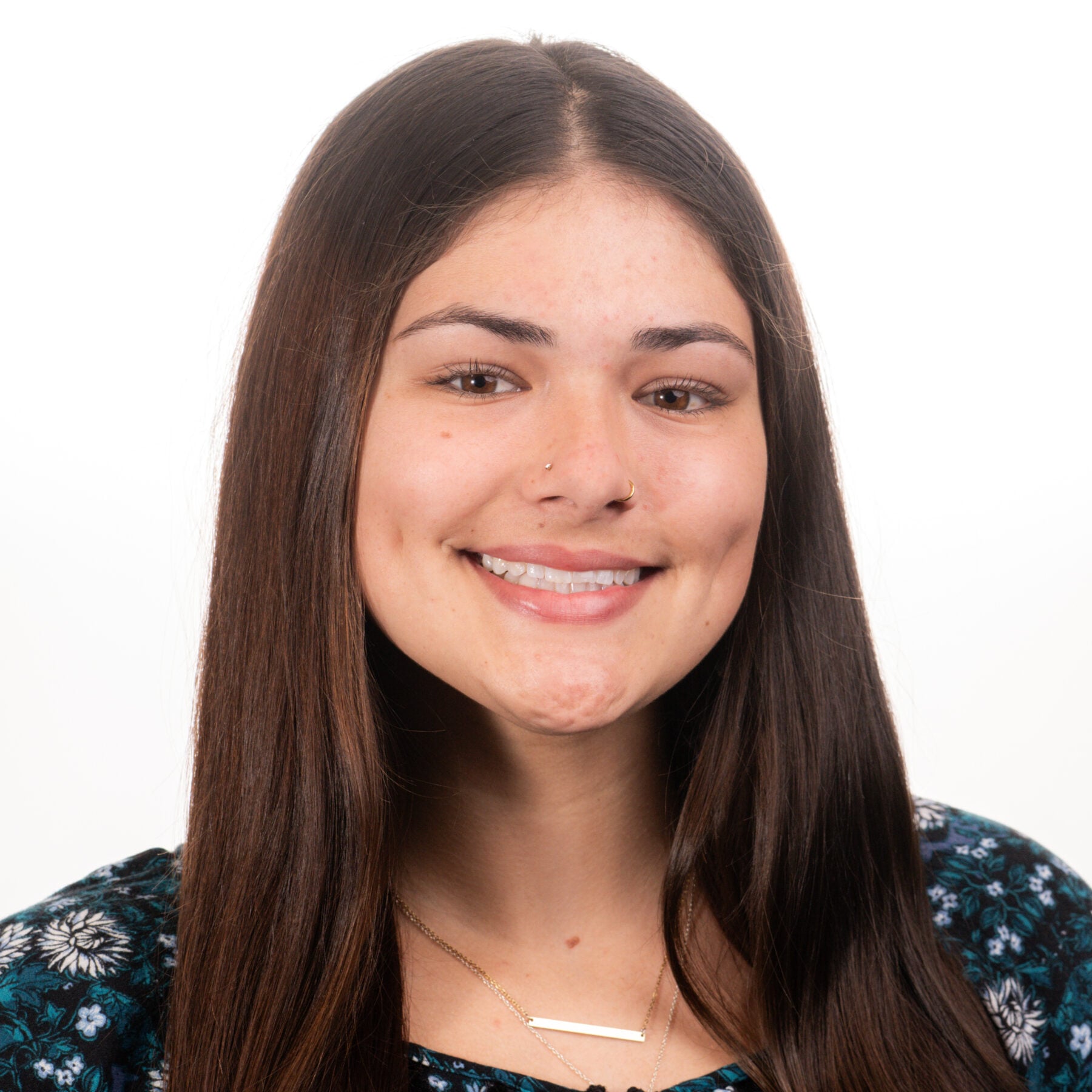 A friendly real estate agent smiling, ready to assist with home buying and selling needs for Farrell Realty.
